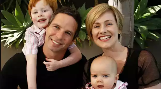 Brad Hodge with wife and baby